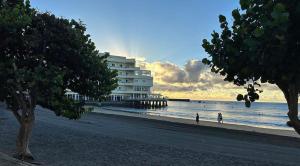 a building on a beach next to the ocean at Médano Beach Blue in El Médano