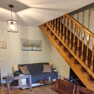 a living room with a blue couch and a staircase at Entre Potes y Picos in Turieno