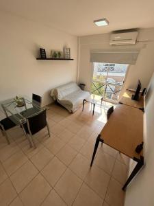 ein Wohnzimmer mit einem Bett und einem Tisch in der Unterkunft Departamento Ciudad Jardín in Billinghurst
