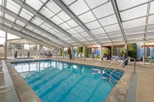 a large swimming pool with a glass ceiling at Best Western Plus Coeur d'Alene Inn in Coeur d'Alene
