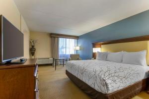 a hotel room with a bed and a flat screen tv at Best Western Plus Coeur d'Alene Inn in Coeur d'Alene