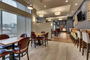 un comedor con mesas y sillas en un restaurante en Drury Plaza Hotel Cincinnati Florence, en Florence