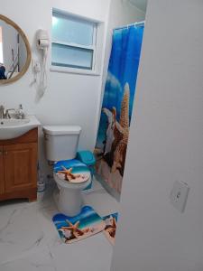 a bathroom with a toilet with a mermaid shower curtain at B6 Best Value on Private Bedroom with Private Bathroom in Little Havana, Miami in Miami