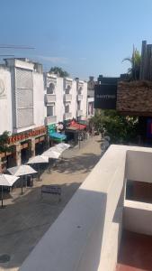 a group of white benches on a street with buildings at Hotel BLVD in Playa del Carmen