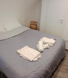 two white towels are sitting on a bed at Casa Vacanza Altamura in Altamura