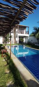 a swimming pool in front of a house at Casa Vila Prea Jericoacoara é logo ali in Prea