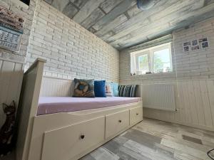 a small room with a bed in a brick wall at Вила Вилекула in Varna City