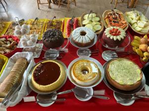 a table topped with lots of different types of desserts at Pousada Kaliman Luxo in Campos do Jordão