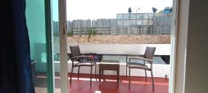 a glass table and chairs on a balcony at Hotel BLVD in Playa del Carmen