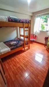 a room with two bunk beds and a wooden floor at ECO ART Best view Machu Picchu in Machu Picchu