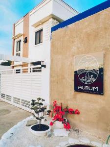 a sign on the side of a building with flowers at Aurum Hot Spring Resort in Los Baños +10 photos