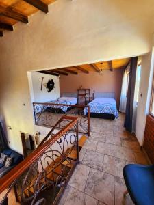 a view of a room with two beds and a staircase at Villa Lakota By Natut Huasca in Huasca de Ocampo