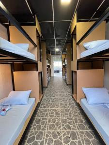 a corridor of a dorm room with bunk beds at Asha Hostel in Fortuna