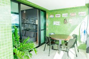 um pátio com uma mesa e cadeiras em uma varanda em Apartamento de luxo em Salvador