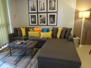 a living room with a couch and a table at Condominium at Carola in Nasugbu