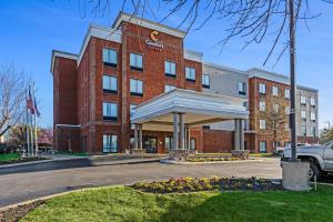 a red brick building with a sign on it at Comfort Suites Murfreesboro Shopping District in Murfreesboro