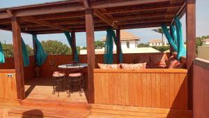 a patio with a table and chairs on a deck at Marinazur in Saidia 