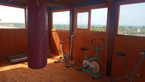 a room with three exercise bikes and windows at Marinazur in Saidia 