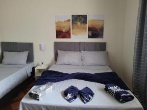 a bedroom with two beds with bow ties on them at Casa serra do Caparaó in Caparaó Velho