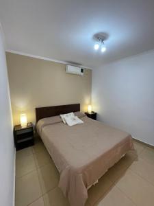 Un dormitorio con una cama con dos luces. en Ayres de chajari en Chajarí