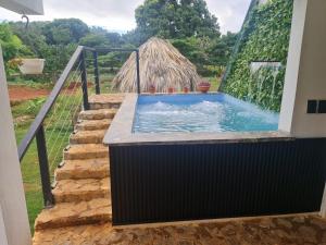 a swimming pool in a house with a fence at Dreamvilles Ecovillage Eco Villas with Jacuzzi near Beaches in Las Galeras