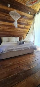 a bedroom with a bed with a wooden ceiling at Dreamvilles Ecovillage Las Galeras in Las Galeras