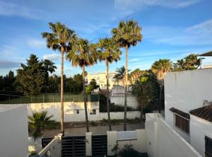 a view of palm trees from the balcony of a building at Villa Marina in Marina Smir