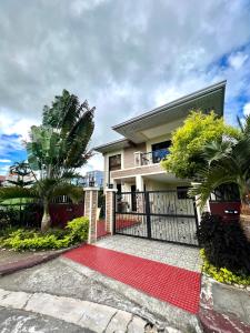 a house with a gate and a red carpet at Sierra Pines Place Tagaytay in Tagaytay