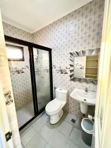 a bathroom with a toilet and a sink at Sierra Pines Place Tagaytay in Tagaytay