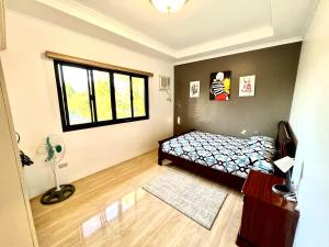 1 dormitorio con cama y ventana en Sierra Pines Place Tagaytay en Tagaytay