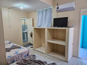 a room with a bedroom with a bed and a television at POUSADA MAR DE IRACEMA in Fortaleza +21 photos