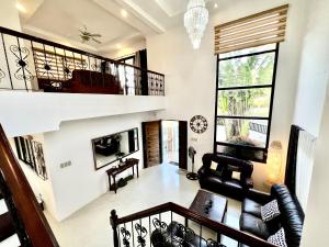 a living room with a staircase and a couch at Sierra Pines Place Tagaytay in Tagaytay