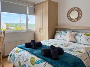 a bedroom with a bed with towels on it at Estuary Retreat in Llanelli