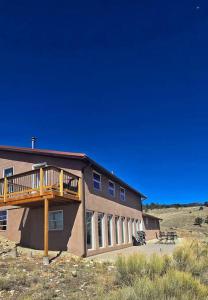 a building with a deck on the side of it at Beautiful quiet getaway in dark skies community. Perfect for a relaxing stay in the mountains in Westcliffe