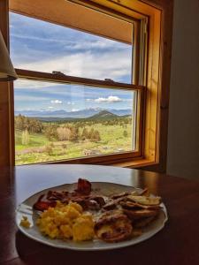 a plate of food on a table in front of a window at Beautiful quiet getaway in dark skies community. Perfect for a relaxing stay in the mountains in Westcliffe