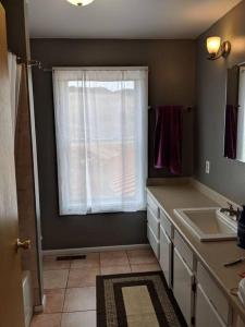 a bathroom with a window with a sink and a counter at Beautiful quiet getaway in dark skies community. Perfect for a relaxing stay in the mountains in Westcliffe