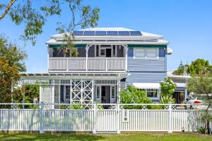 a house with a white fence in front of it at "Xanadu" Charming 2-Bed Retreat by Marcoola Beach in Bli Bli
