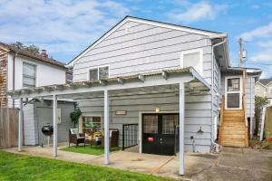 a white house with an awning at Cozy Getaway Yard House with BBQ - UW - Children Hospital in Seattle