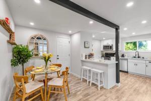 a kitchen and dining room with a table and chairs at Secret & Cozy Renovated Cottage Near Costco I99 in Shoreline