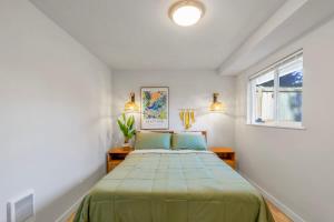 a bedroom with a large bed in a white room at Secret & Cozy Renovated Cottage Near Costco I99 in Shoreline