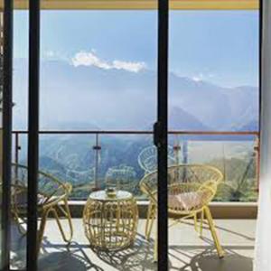 a balcony with chairs and a table and a view at Sunny Sapa Homestay in Sa Pa
