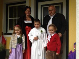 a family posing for a picture in front of a house at Landhaus Gabriele in Filzmoos