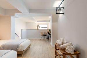 a bedroom with a bed and a table with towels at Nice new duplex in front of Palacio VistaAlegre in Madrid