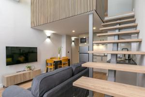 a living room with a couch and a table at Nice new duplex in front of Palacio VistaAlegre in Madrid