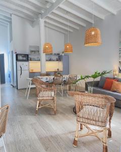 a living room with a couch and a table and chairs at Loft de playa in Mar del Plata