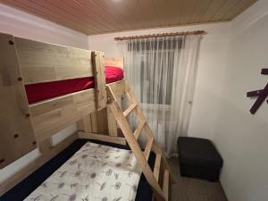 a bedroom with a bunk bed with a ladder at Ferienbungalow Meerjungfrau im Seebad Ueckermünde in Ueckermünde +20 photos