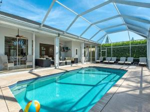 an indoor swimming pool with a glass roof at Lux Family 3 BR With Pool Villa Walk To Beach and Mercato in Naples