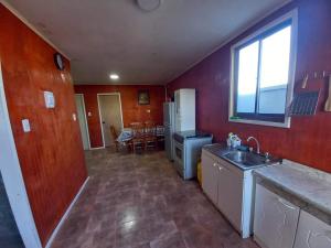 a kitchen with a sink and a counter top at Cabañas con tinajas coronel in Coronel