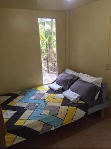a bedroom with a bed with a colorful quilt at Destiny Rainbow Beach Resort in Siquijor