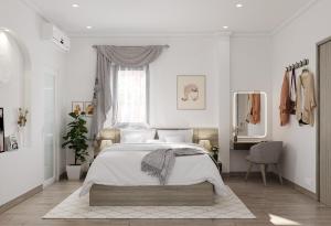 a white bedroom with a bed and a mirror at Montcalm Hotel Saigon in Ho Chi Minh City